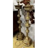 A pair of large Dutch embossed brass altar sticks converted to electricity, height 150cm