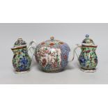 Two Chinese Kangxi clobbered jugs and covers, and a 19th century famille rose teapot, 13cms high