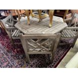 An octagonal weathered teak garden table, length 126cm, height 69cm and four teak elbow chairs