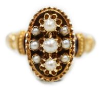 An early 20trh century French yellow metal (18ct poincon mark) and seed pearl cluster set oval ring,