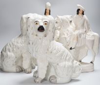 A pair of Staffordshire pottery spaniels, 30cm high, and a pair of equestrian groups, 19th century