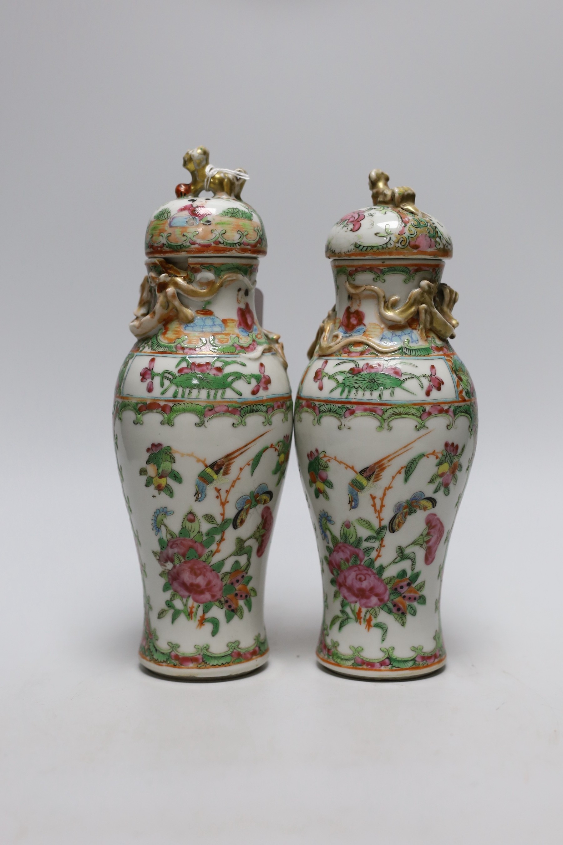 A pair of 19th century Chinese famille rose vases and covers, 24cms high