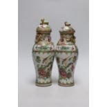 A pair of 19th century Chinese famille rose vases and covers, 24cms high
