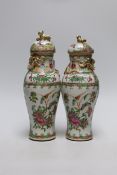 A pair of 19th century Chinese famille rose vases and covers, 24cms high
