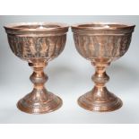 A pair of Persian copper figural decorated chalices, 27cms high