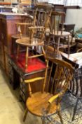 An early 20th century harlequin set of six Windsor elm and beech dining chairs, two with arms