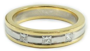 A modern Simbol two colour 18ct gold and gypsy set three stone diamond band, size M, gross weight