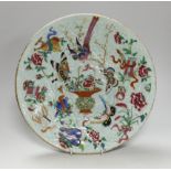 A 19th century Chinese famille rose enamelled carved celadon glazed dish, 34cm