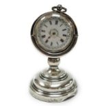 A George V silver mounted fob watch stand, Birmingham, 1923, 79mm, containing a Swiss white metal