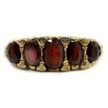 A 1960's Victorian style 9ct gold and graduated five stone garnet set half hoop ring, with diamond