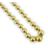 A French? graduated yellow metal bead necklace, 42cm, gross 21.4 grams.