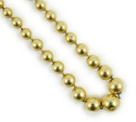 A French? graduated yellow metal bead necklace, 42cm, gross 21.4 grams.