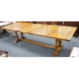 A reproduction 18th century style oak extending refectory dining table, length 306cm extended, one