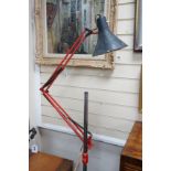 A converted industrial style anglepoise standard lamp on cast metal wheeled stand