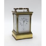 A large brass cased carriage clock retailed by St. James, 17cm