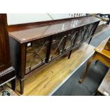 An Edwardian glazed mahogany dwarf bookcase, enclosed by six astragal glazed sliding doors, width