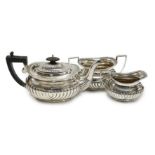 A George V demi fluted silver three piece bachelor's tea set, Jones & Crompton, Birmingham, 1913,