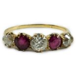 A yellow metal, three stone diamond and two stone ruby set half hoop ring, size V, gross weight 3.