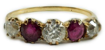 A yellow metal, three stone diamond and two stone ruby set half hoop ring, size V, gross weight 3.
