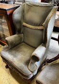 A Queen Anne revival upholstered wing armchair, width 71cm, depth 62cm, height 110cm