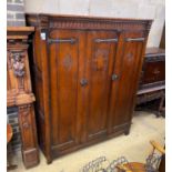 A 17th century style oak three door wardrobe, width 150cm, depth 61cm, height 183cm