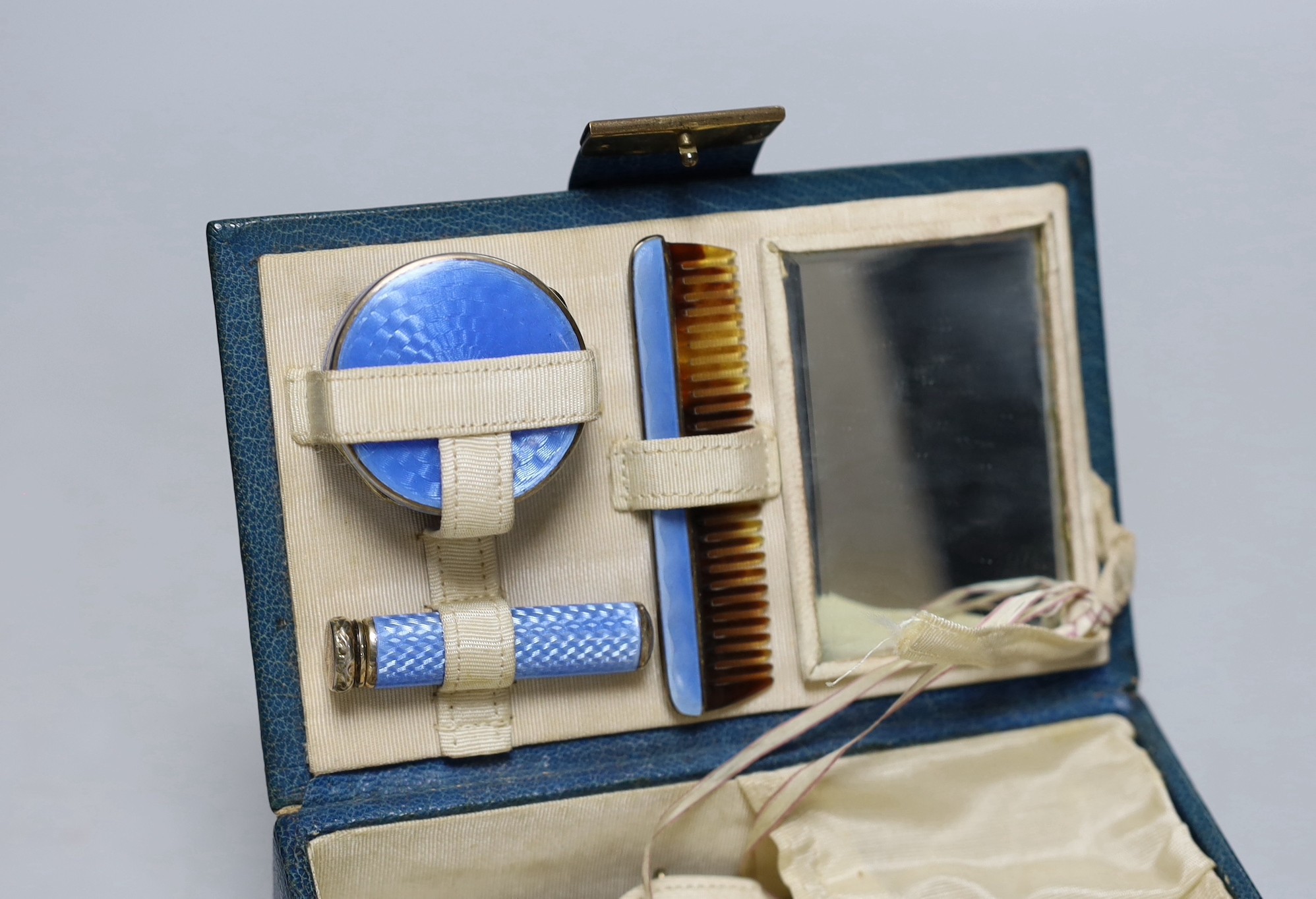 A lady's 1920's small leather vanity case, containing an enamelled comb, pill box and lipstick - Image 2 of 3