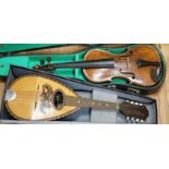 A late 19th century German violin together with an Italian mandolin, (both cased)