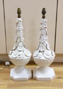 A pair of white glazed floral encrusted lamps, 58cms high not including light fitting