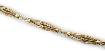 An 18k yellow metal fancy link bracelet with 14k clasp, 21cm, 10.7 grams.