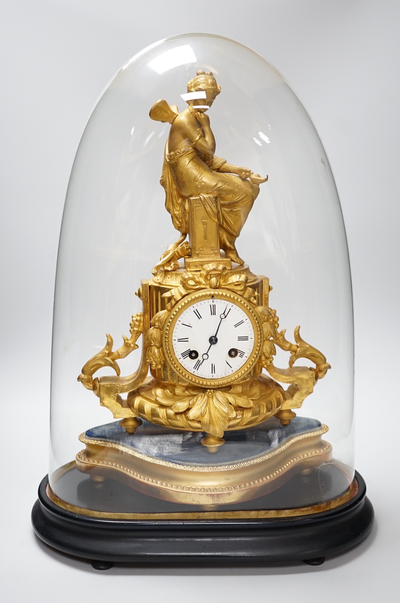 A French 19th century gilt metal clock by Phillipe H. Mourey on stand with glass dome, total