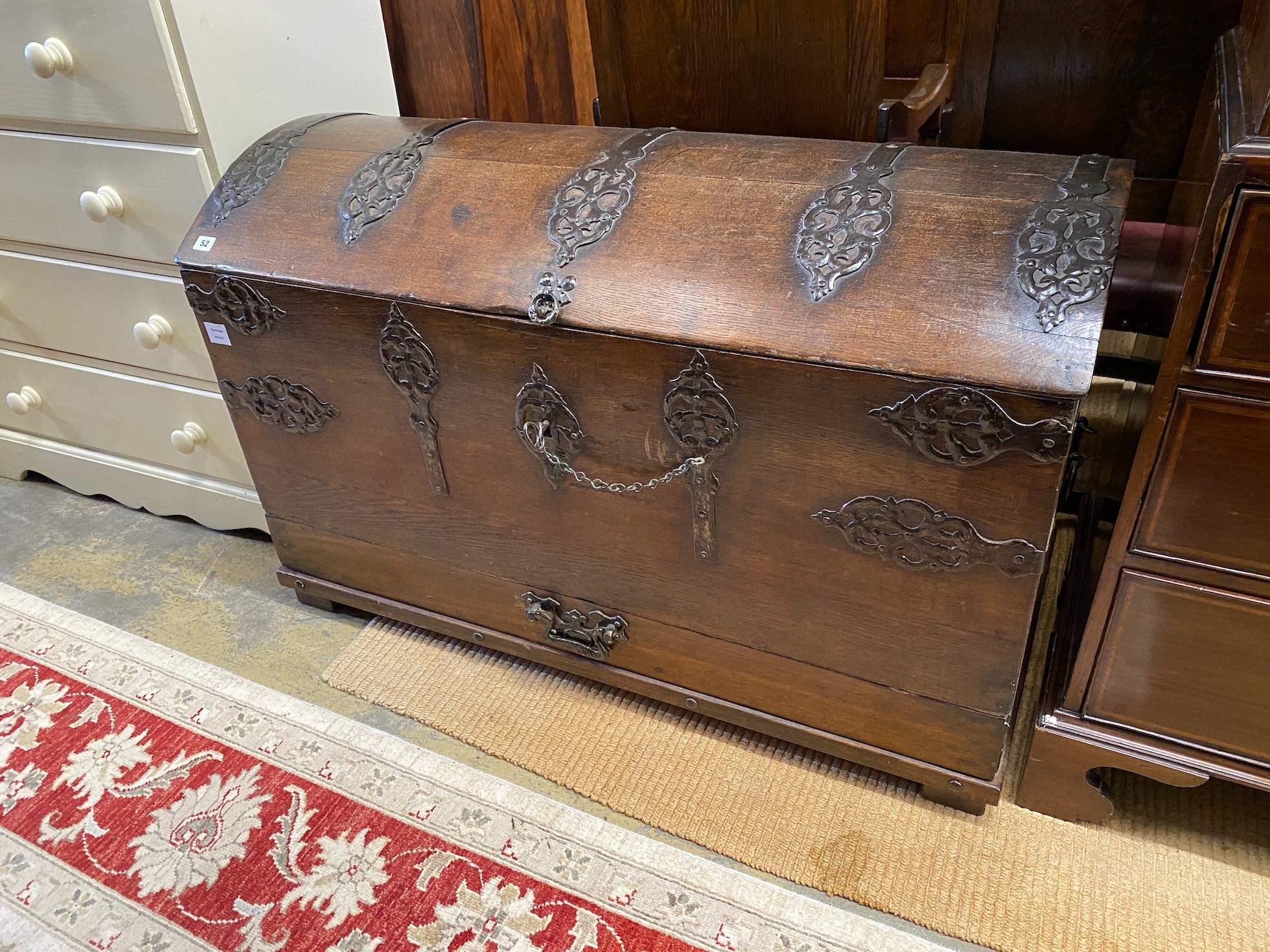 A 17th century style iron bound dome top oak trunk, width 117cm, depth 56cm, height 74cm