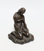 A cast resin figure of a kneeling classical figure, 13.5cms high