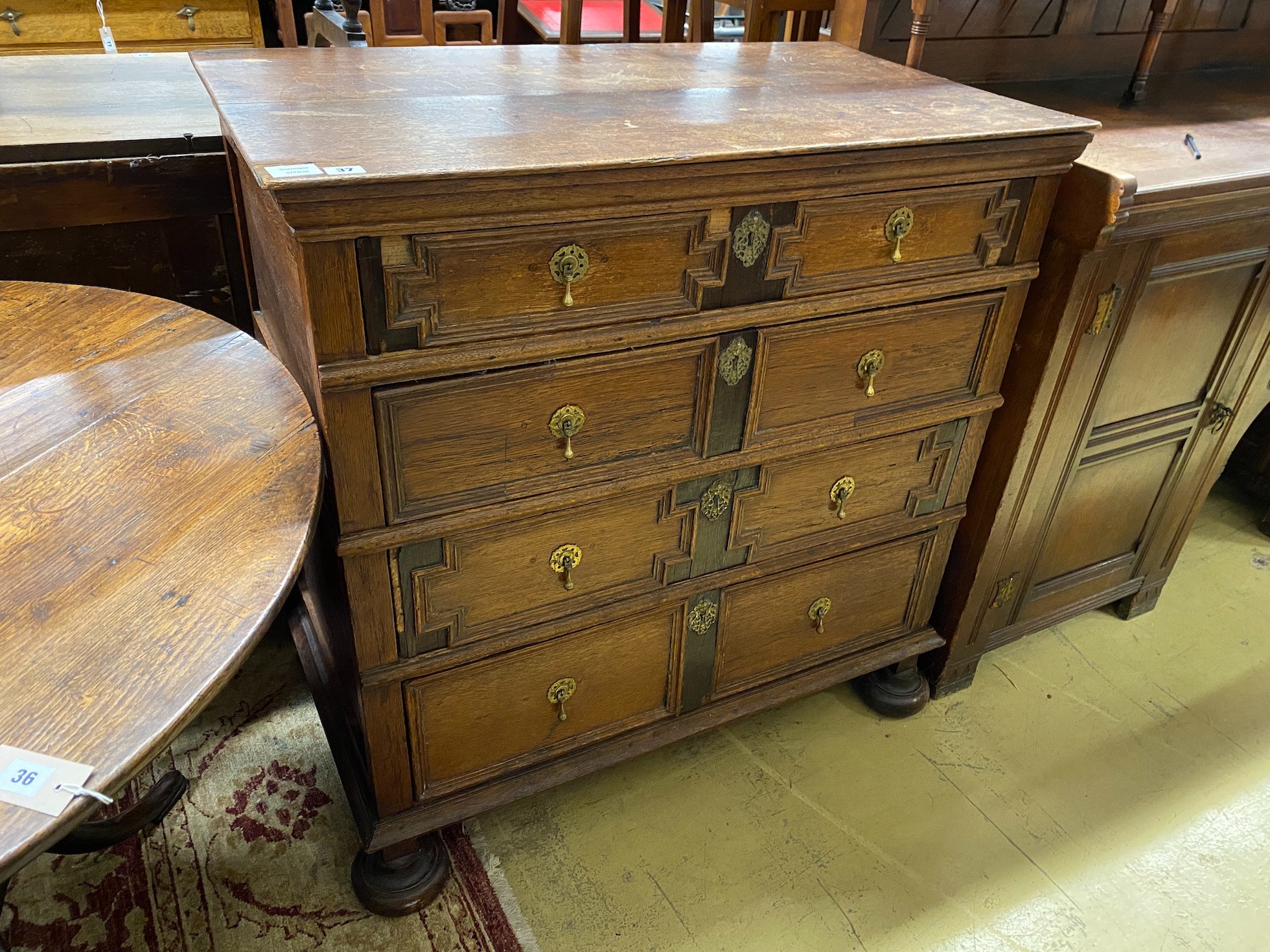 A 17th century style oak geometric four drawer chest, width 97cm, depth 54cm, height 99cm