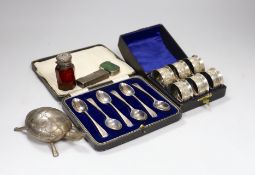 A cased set of six George V silver teaspoons, a white metal mounted glass scent bottle, a Dunhill