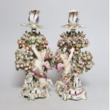 A pair of 18th century Bow putti figural candlesticks, 24cm