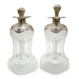 A pair of Edwardian silver mounted glass hour glass shaped decanters, William Hutton & Sons,