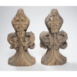 A pair of 16th century oak fleur de lys pew finials, 24cms high