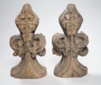 A pair of 16th century oak fleur de lys pew finials, 24cms high