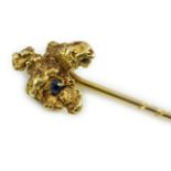 A late Victorian yellow metal and single stone sapphire set 'nugget' stick pin, 62mm, gross weight