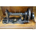 A 19th century mother of pearl decorated John Murdoch sewing machine with wooden case