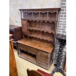 An Arts & Crafts copper mounted oak dresser, width 153cm, depth 53cm, height 210cm