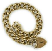 An engraved 9ct gold curb link bracelet, with heart shaped padlock clasp, approx. 18cm, 51.3 grams.