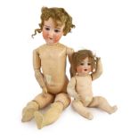 A bisque doll, German, circa 1900, impressed 3, open mouth and weighted glass eyes, jointed wood and