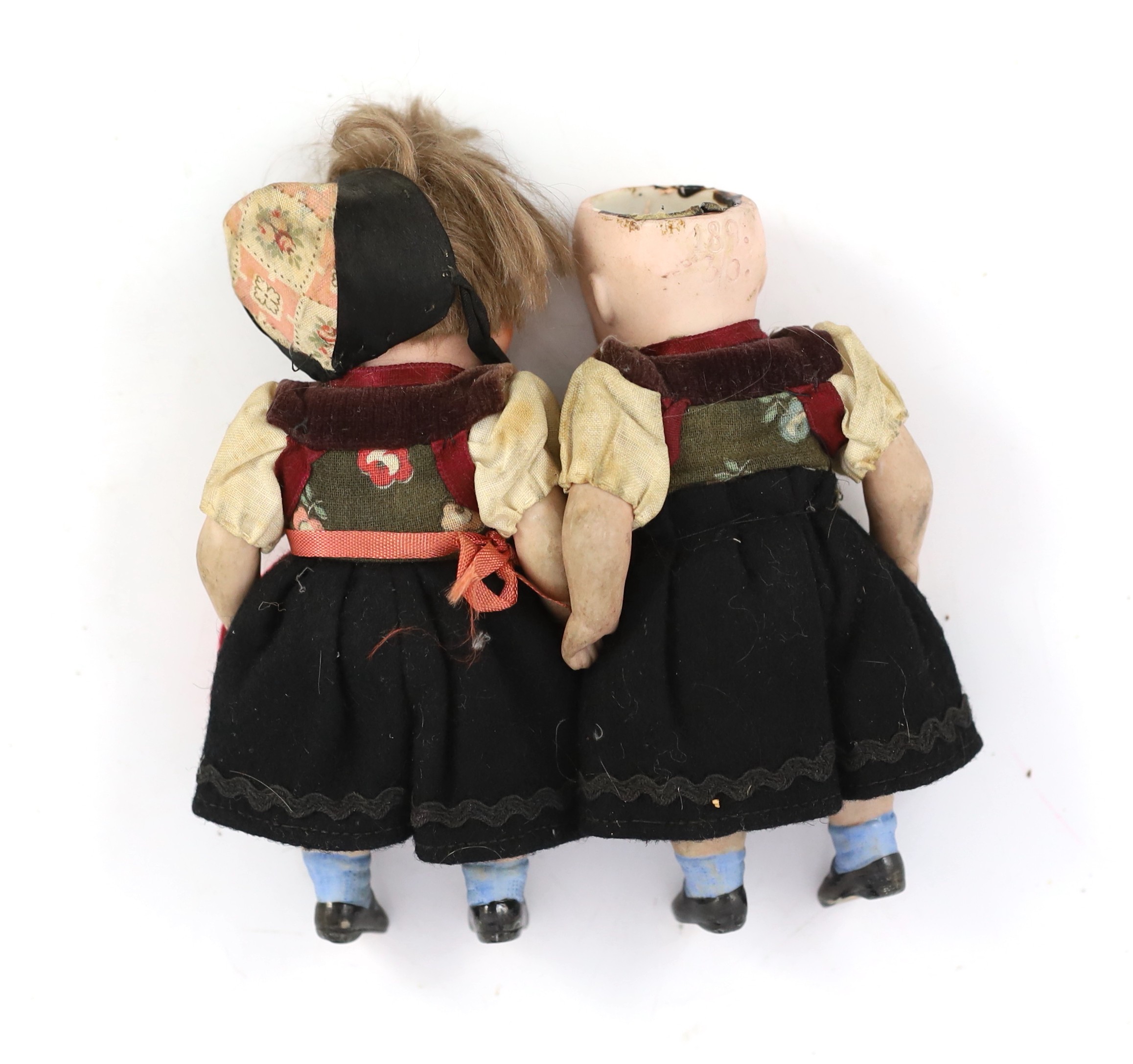 A pair of German all-bisque dolls with 'googlie' eyes, jointed at the hip and shoulder, the feet - Image 2 of 2