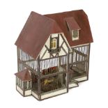 A German ‘birdcage’ dolls’ house, late 19th century, modelled as half-timbered house with red roof