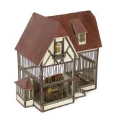 A German ‘birdcage’ dolls’ house, late 19th century, modelled as half-timbered house with red roof