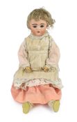 An Adolf Wislizenus bisque doll, German, circa 1910, impressed A.W. 11, with open mouth and upper