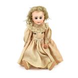 A Jumeau Bisque child doll, circa 1895, on a jointed composition body, with fixed blue eyes,