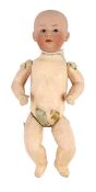 A Gebrüder Heubach bisque character boy doll, German, circa 1912, impressed 0, with closed pouty