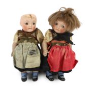 A pair of German all-bisque dolls with 'googlie' eyes, jointed at the hip and shoulder, the feet
